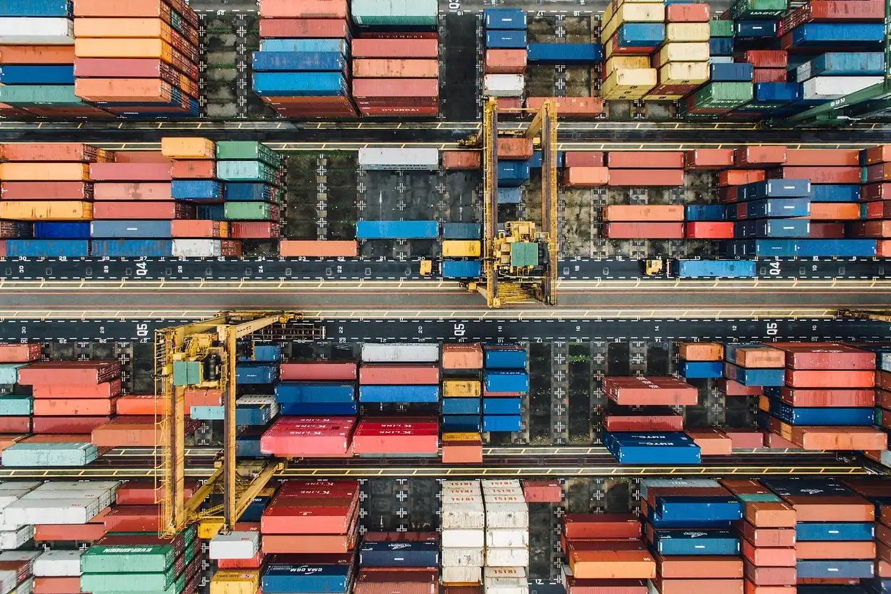 Aerial view of a container terminal with stacked containers and gantry cranes